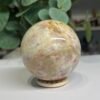 sunstone sphere 6cm 3 Sunstone sphere 6cm, soft peach and cream with golden lines