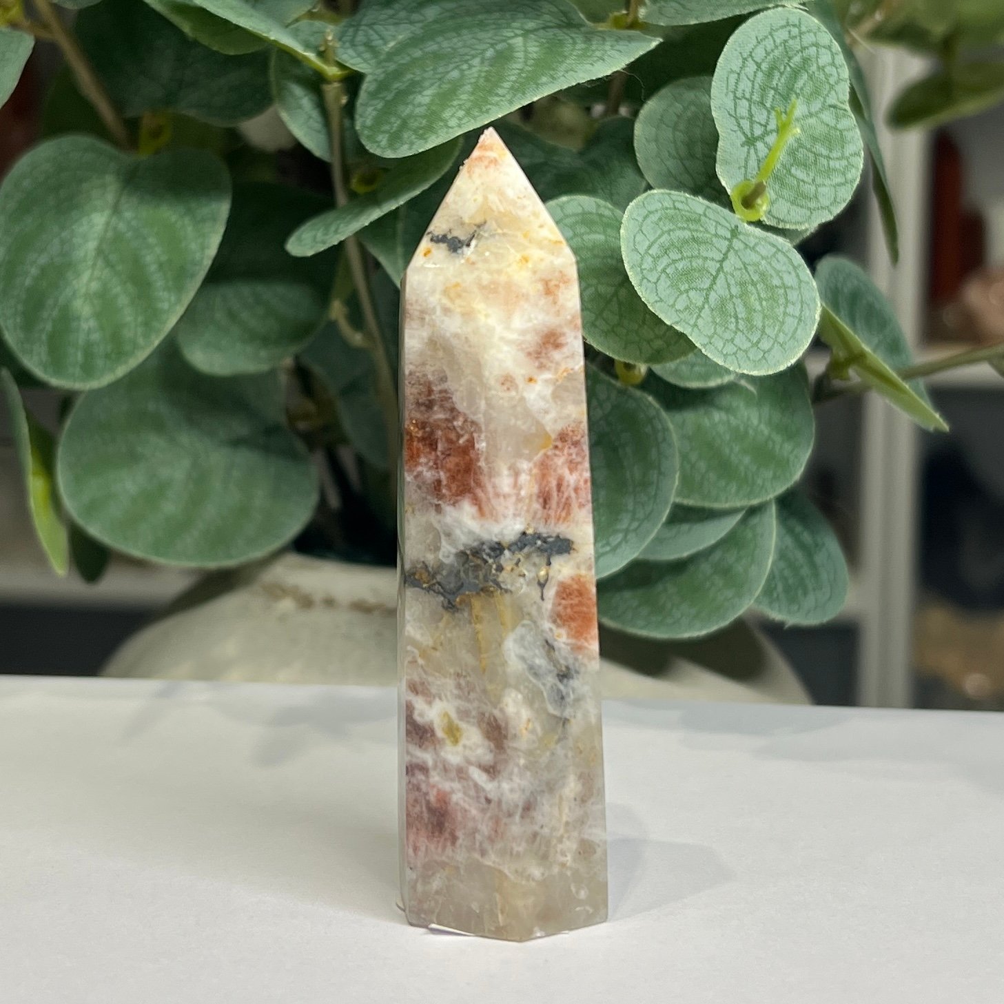 sunstone tower b 9cm Sunstone tower B 9cm, bright orange sunstone with a band of black tourmaline