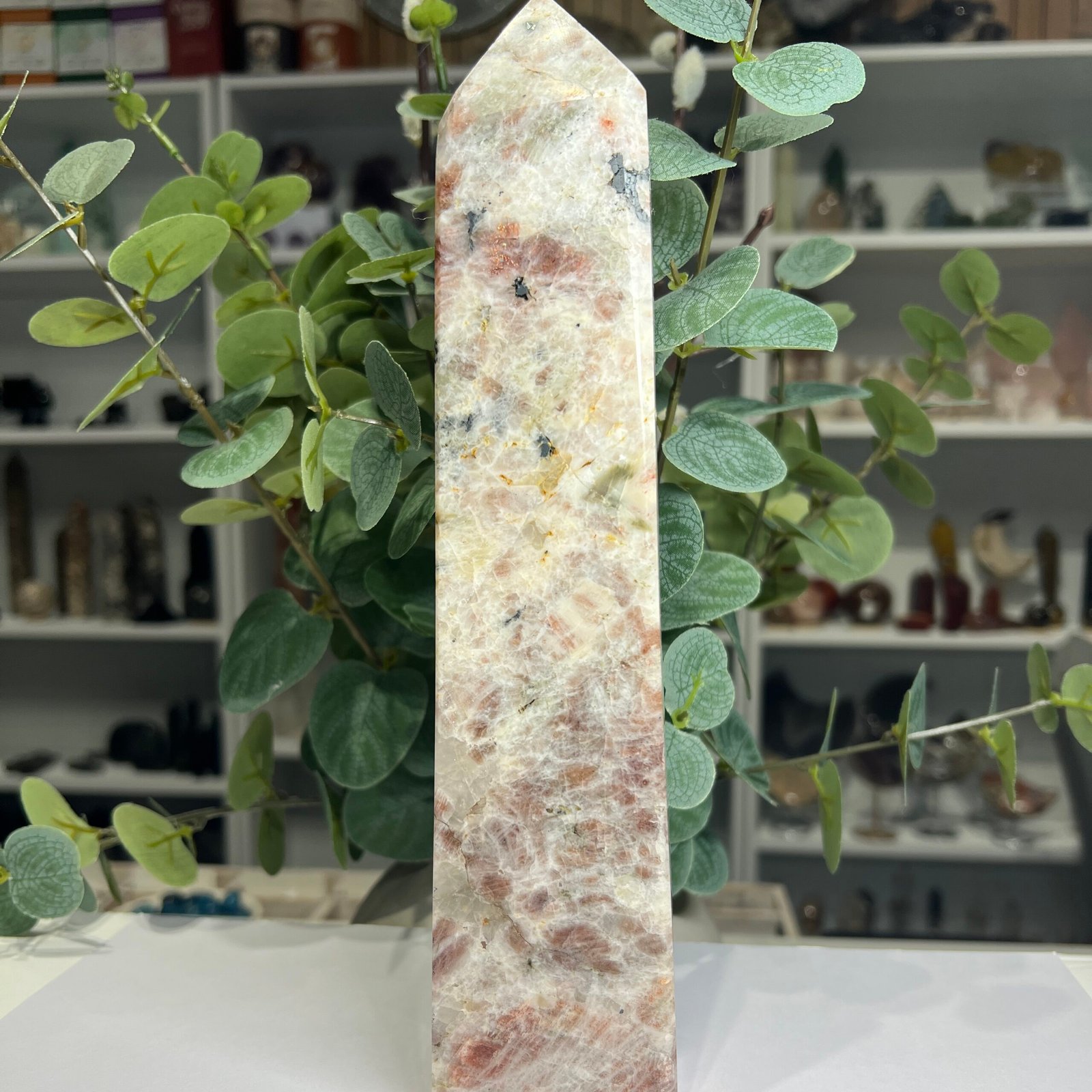 sunstone tower large 26cm Large sunstone tower 26cm, peach sunstone in cream feldspar with black tourmaline near the tip