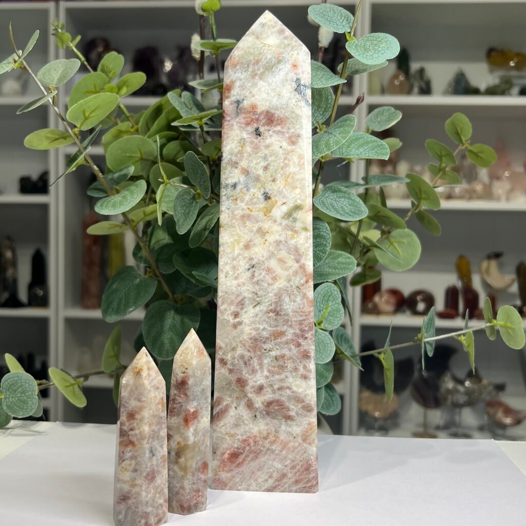 Home 2026 40 Three sunstone towers, a large 26cm tower and two 9cm towers, peach sunstone in cream feldspar, Mystic Grove