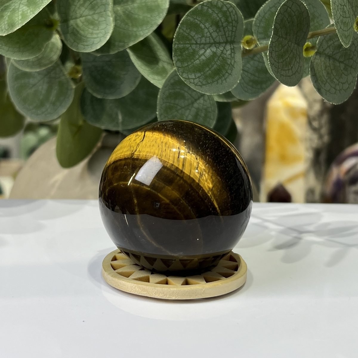 Tigers eye sphere B, 51mm, on wooden stand Tigers eye sphere B, 51mm, on wooden stand