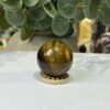 Tigers eye sphere C, 40mm, on wooden stand Tigers eye sphere C, 40mm, on wooden stand