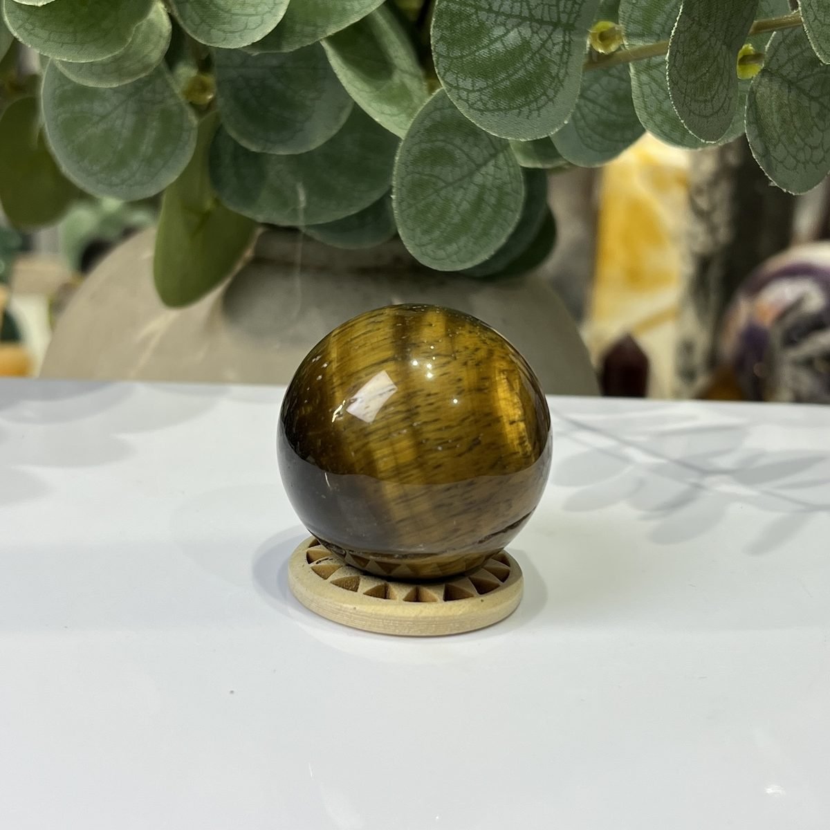 Tigers eye sphere C, 40mm, on wooden stand Tigers eye sphere C, 40mm, on wooden stand