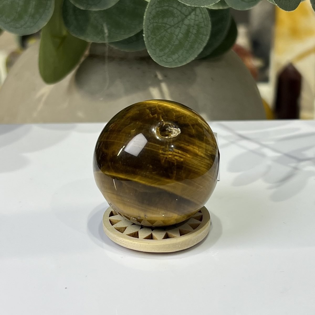 Tigers eye sphere D, 39mm, on wooden stand Tigers eye sphere D, 39mm, on wooden stand