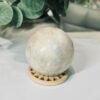 white moonstone sphere 6cm 276g White moonstone sphere 6cm, soft cream and pale grey with a gentle sheen, on a wooden sphere stand